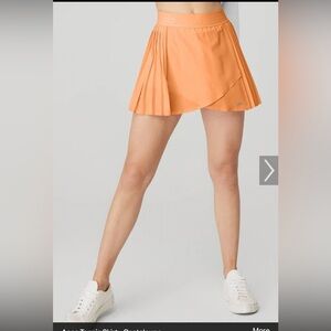 ALO Yoga Aces Pleated Tennis Skort in Cantaloupe Orange